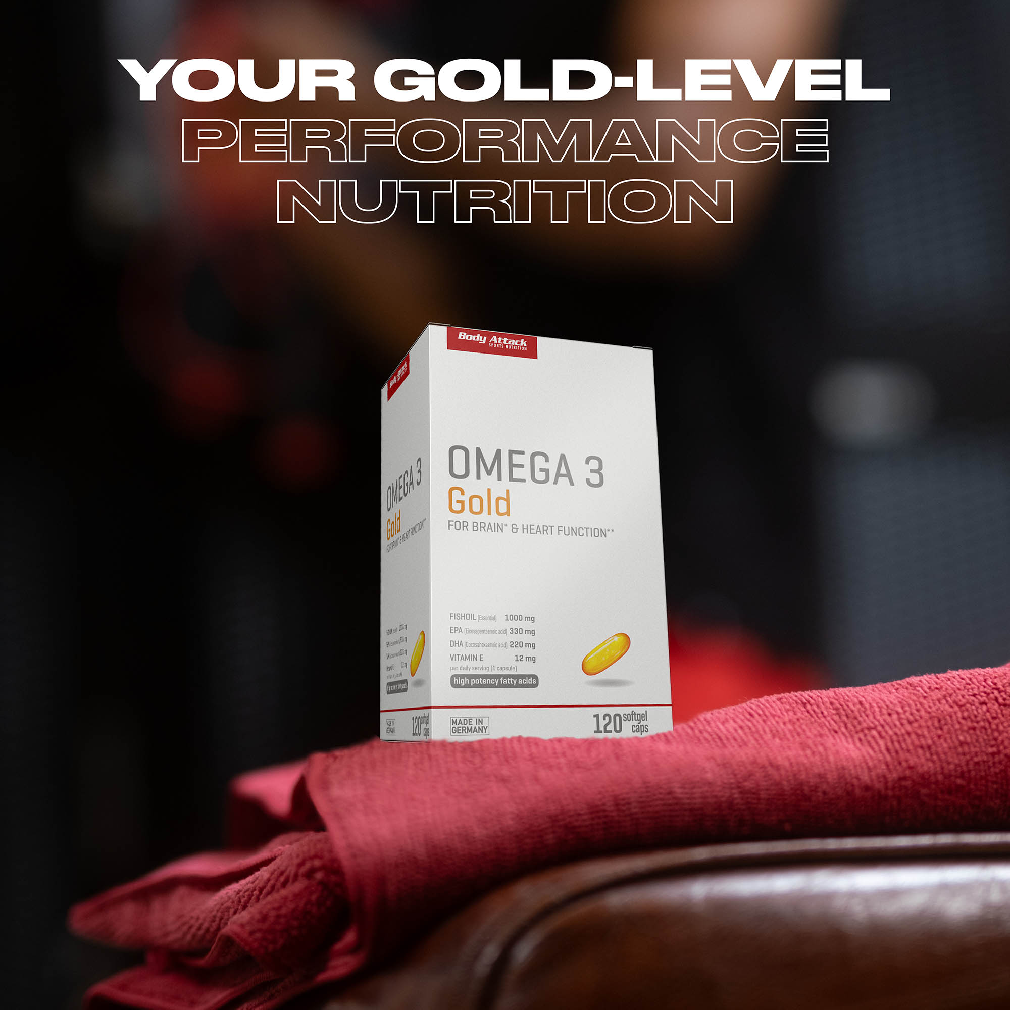 Omega 3 Gold Packung steht auf einem Roten Handtuch mittig im Bild